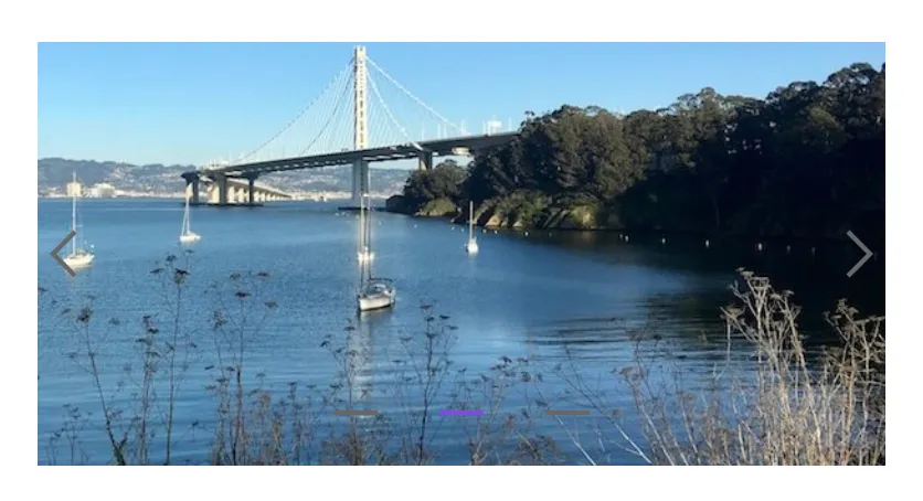 An example of a carousel from the Grommet. A landscape scene is overlaid with barely visible arrow controls on the left and right sides.