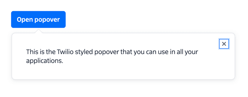 An example of a popover from the Twilio Paste Design System. A button with the label 'Open Popover' is shown with a bubble below containing text and a close icon. A small arrow is pointing from the bubble to the button.